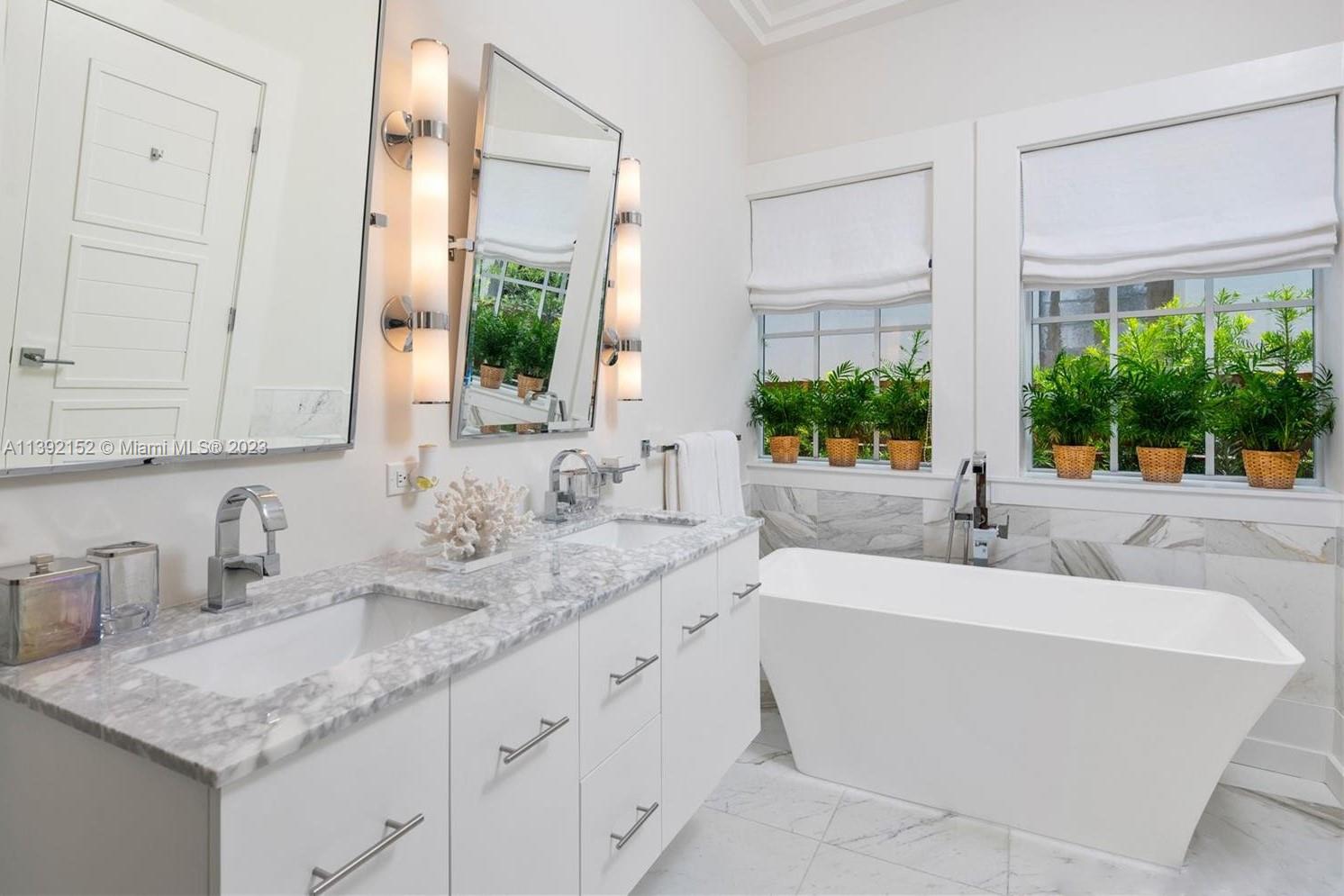 2575 Pine Tree Drive Miami Beach, FL 33140 - Photo 20 of 37 a bathroom with a granite countertop sink and a mirror