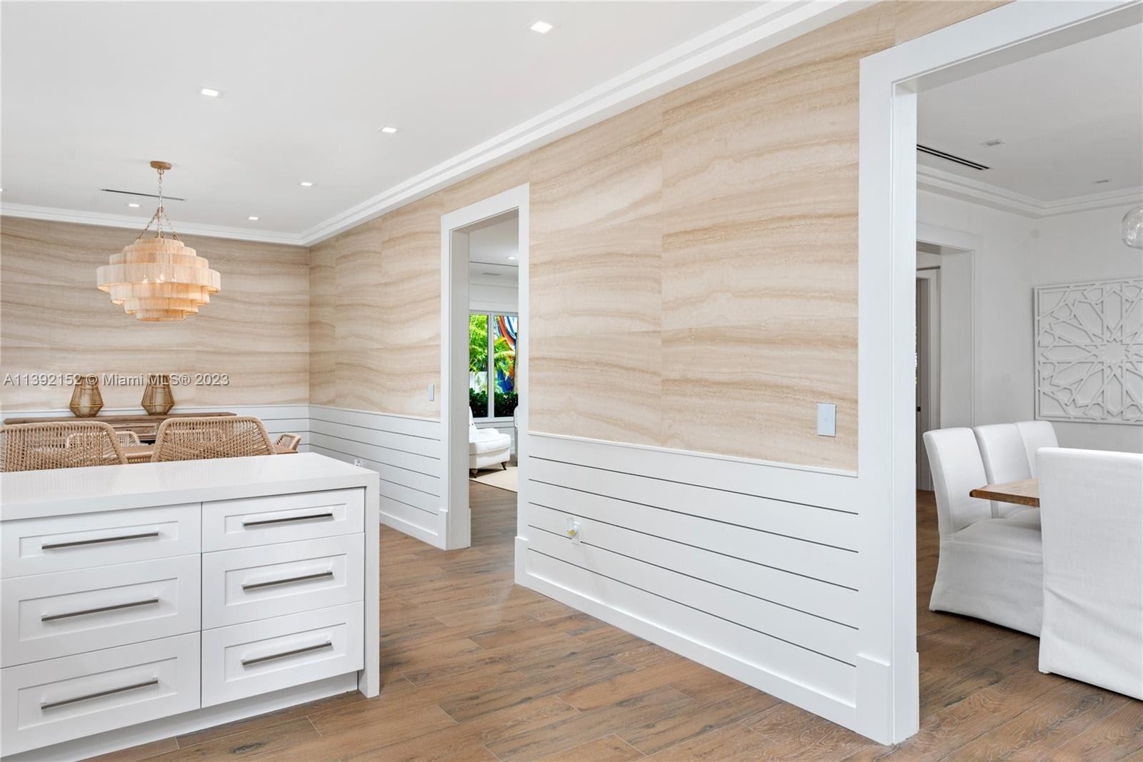 2575 Pine Tree Drive Miami Beach, FL 33140 - Photo 6 of 37 a bathroom with a sink a mirror and a shower