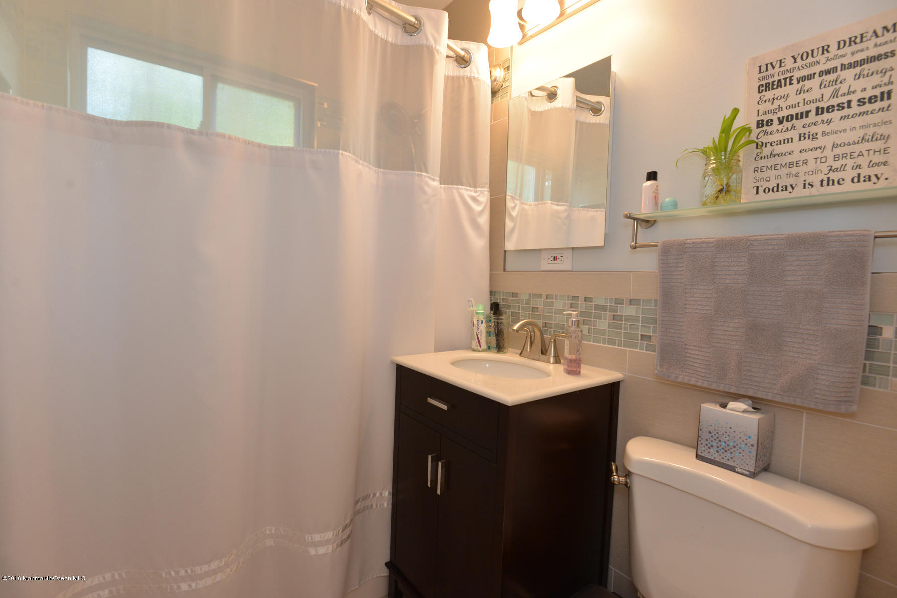 512 Lakewood Road Neptune Township, NJ 07753 - Photo 12 of 28 a bathroom with a sink a toilet and a mirror