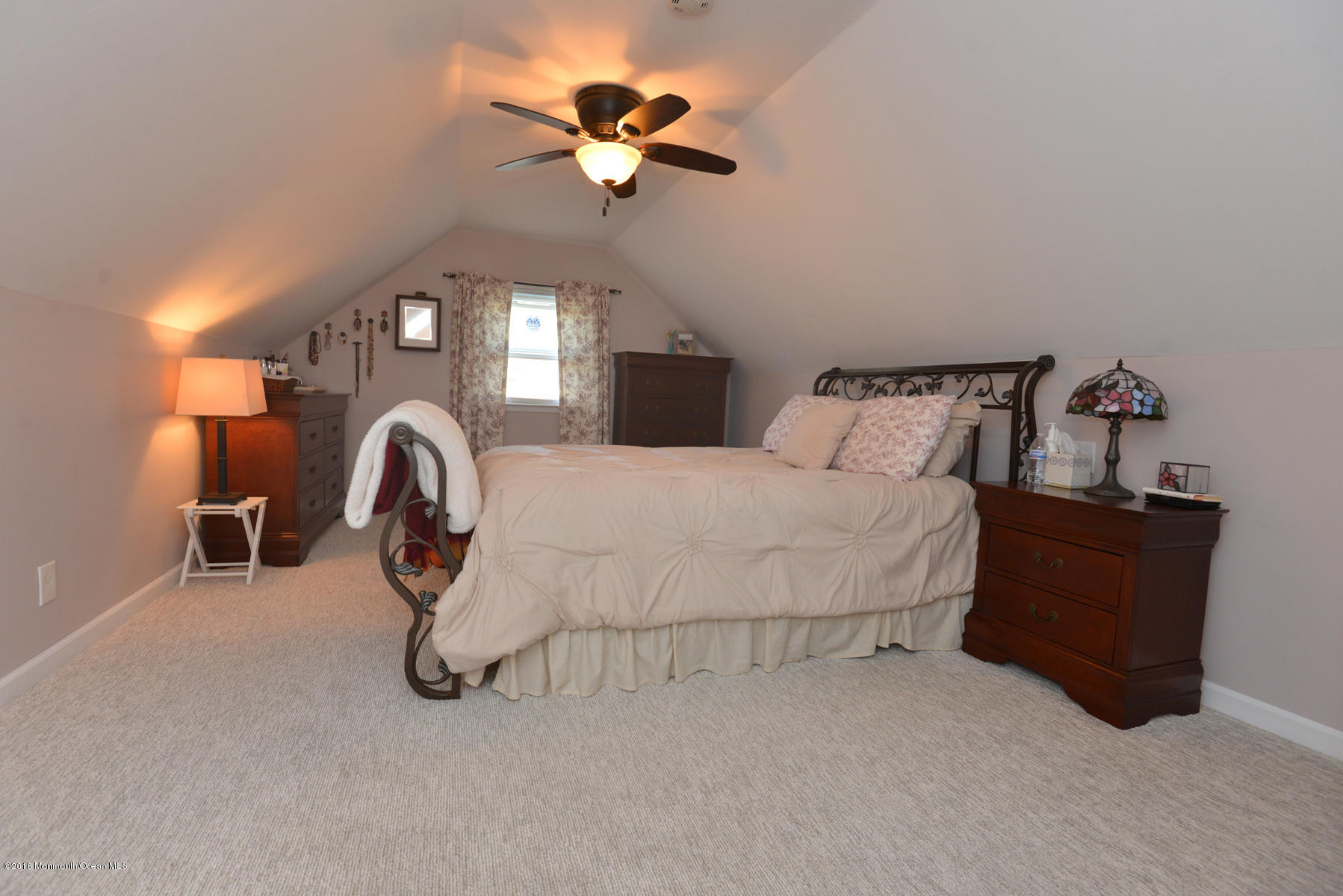 512 Lakewood Road Neptune Township, NJ 07753 - Photo 13 of 28 a bed room with a bed and a chandelier