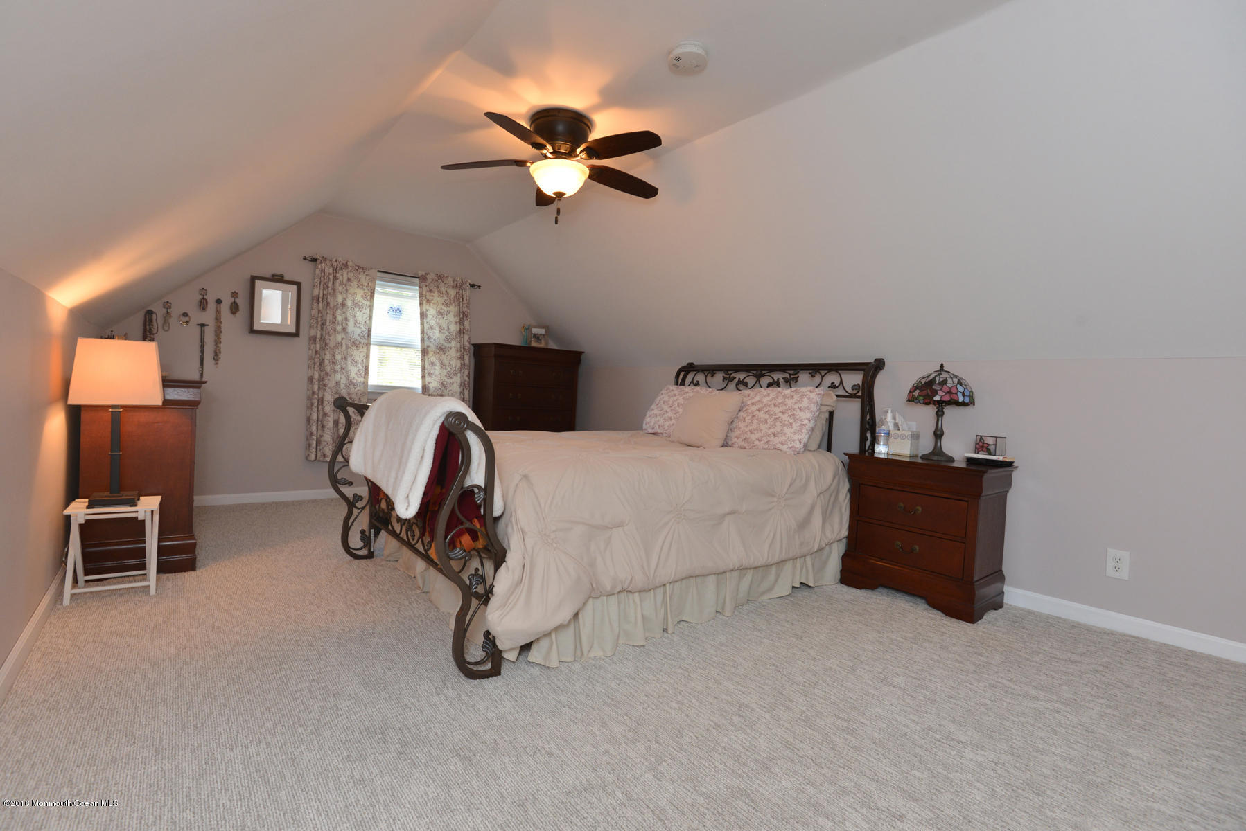 512 Lakewood Road Neptune Township, NJ 07753 - Photo 14 of 28 a bedroom with a bed and a chandelier