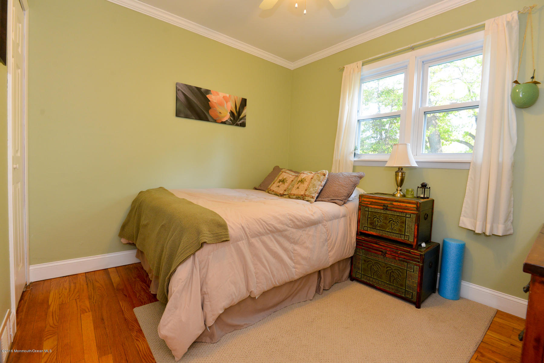 512 Lakewood Road Neptune Township, NJ 07753 - Photo 15 of 28 a bedroom with a bed and wooden floor