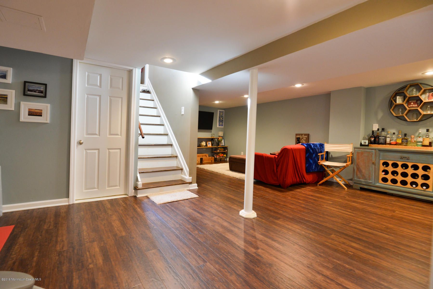 512 Lakewood Road Neptune Township, NJ 07753 - Photo 16 of 28 a living room with furniture and stairs with wooden floor