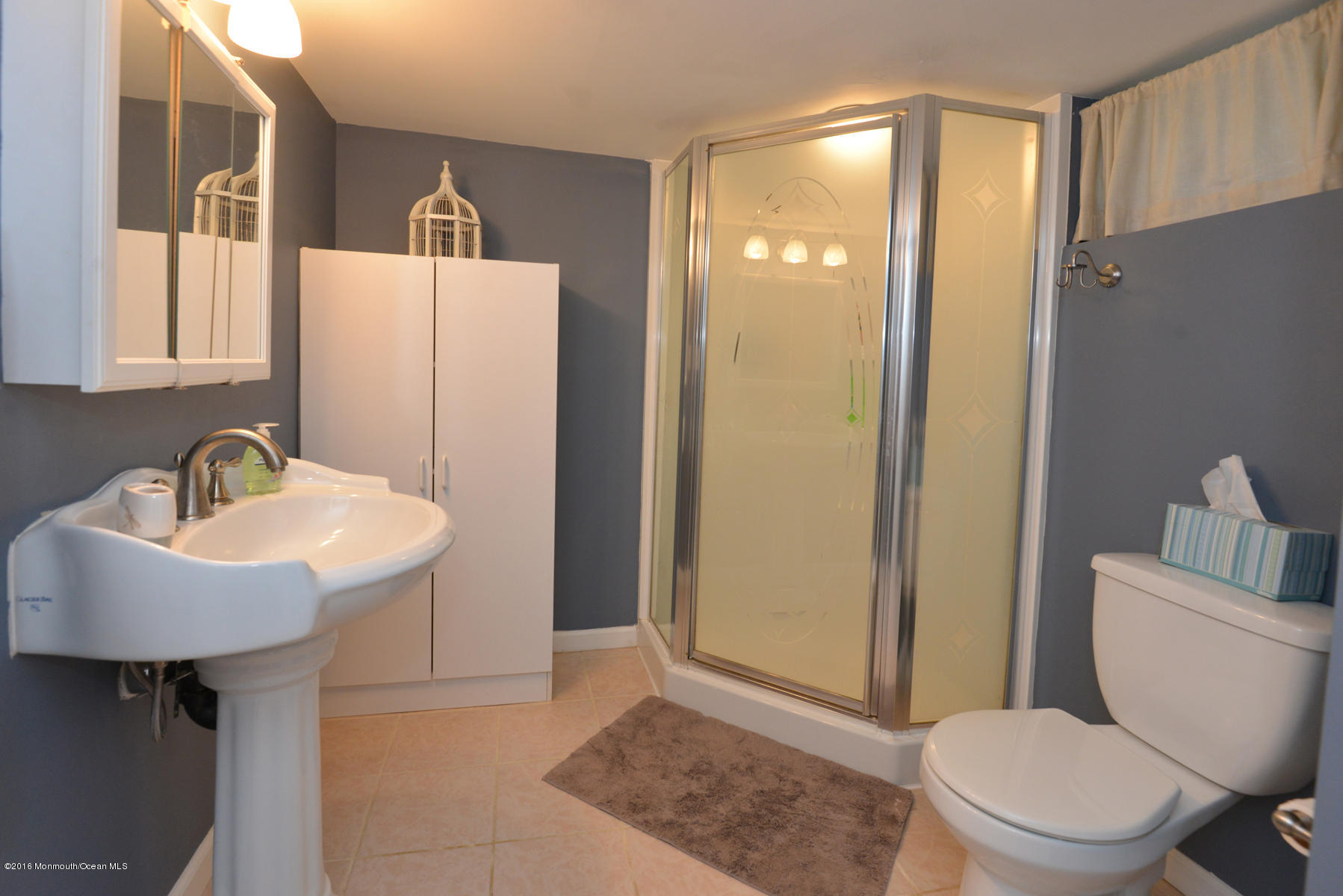 512 Lakewood Road Neptune Township, NJ 07753 - Photo 21 of 28 a bathroom with a toilet a sink and mirror