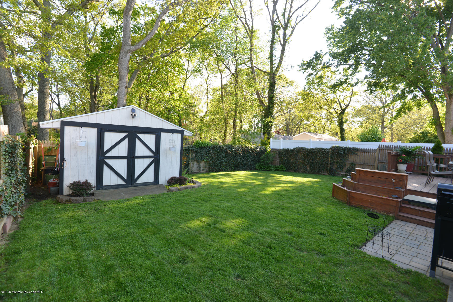 512 Lakewood Road Neptune Township, NJ 07753 - Photo 26 of 28 a view of a yard with a bench and a tree