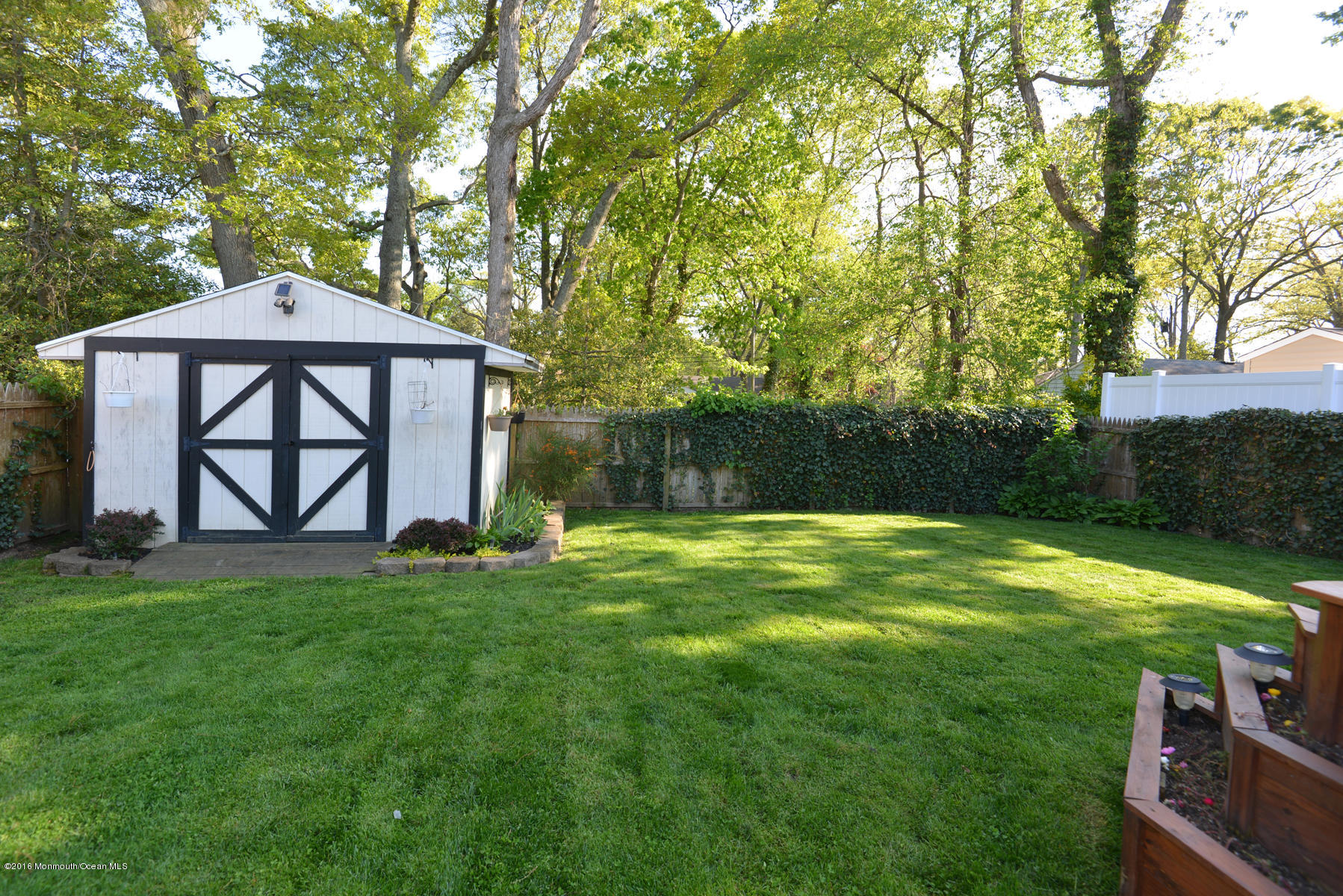 512 Lakewood Road Neptune Township, NJ 07753 - Photo 27 of 28 a backyard of a house with lots of green space