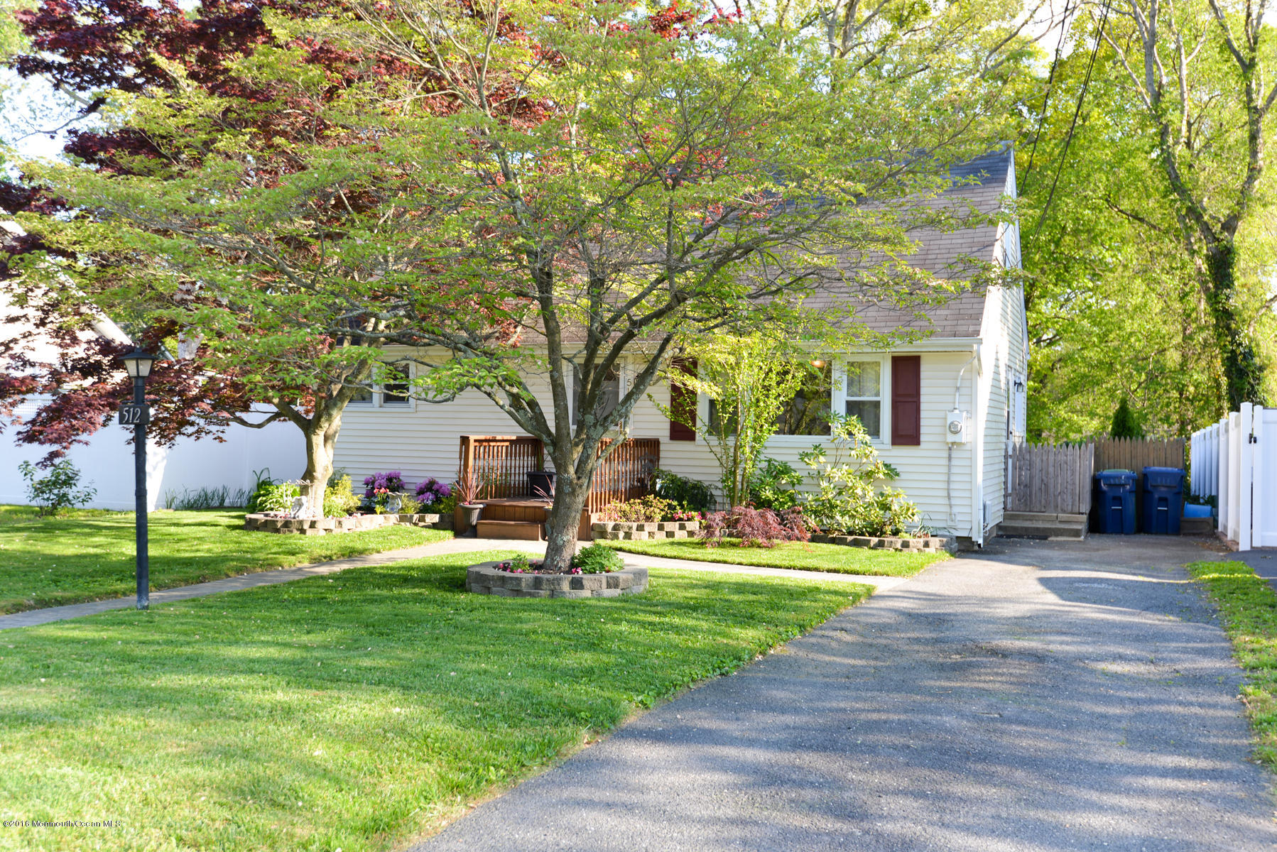 512 Lakewood Road Neptune Township, NJ 07753 - Photo 3 of 28 a front view of a house with garden and trees