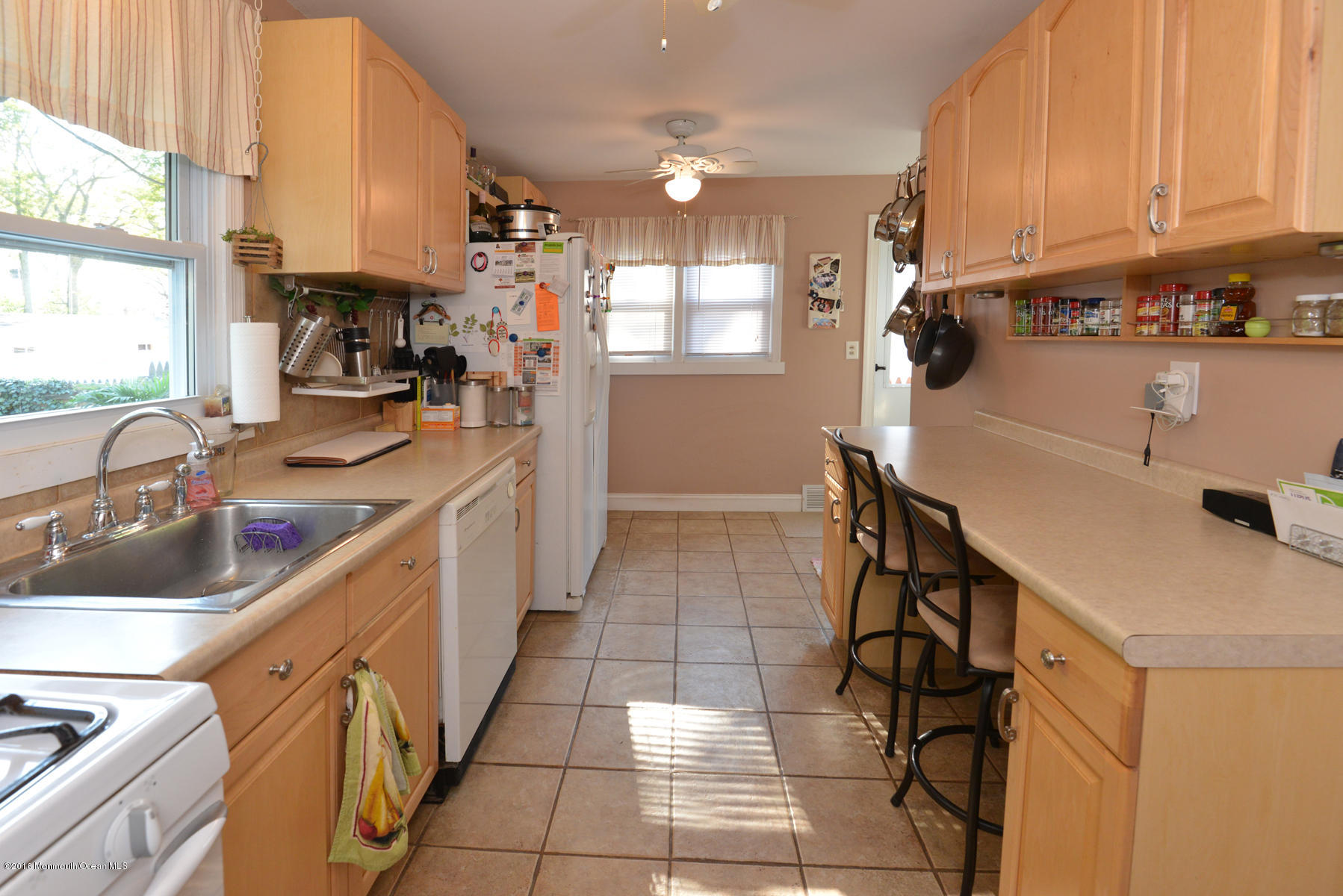 512 Lakewood Road Neptune Township, NJ 07753 - Photo 6 of 28 a kitchen with granite countertop a sink appliances cabinets and a counter top space