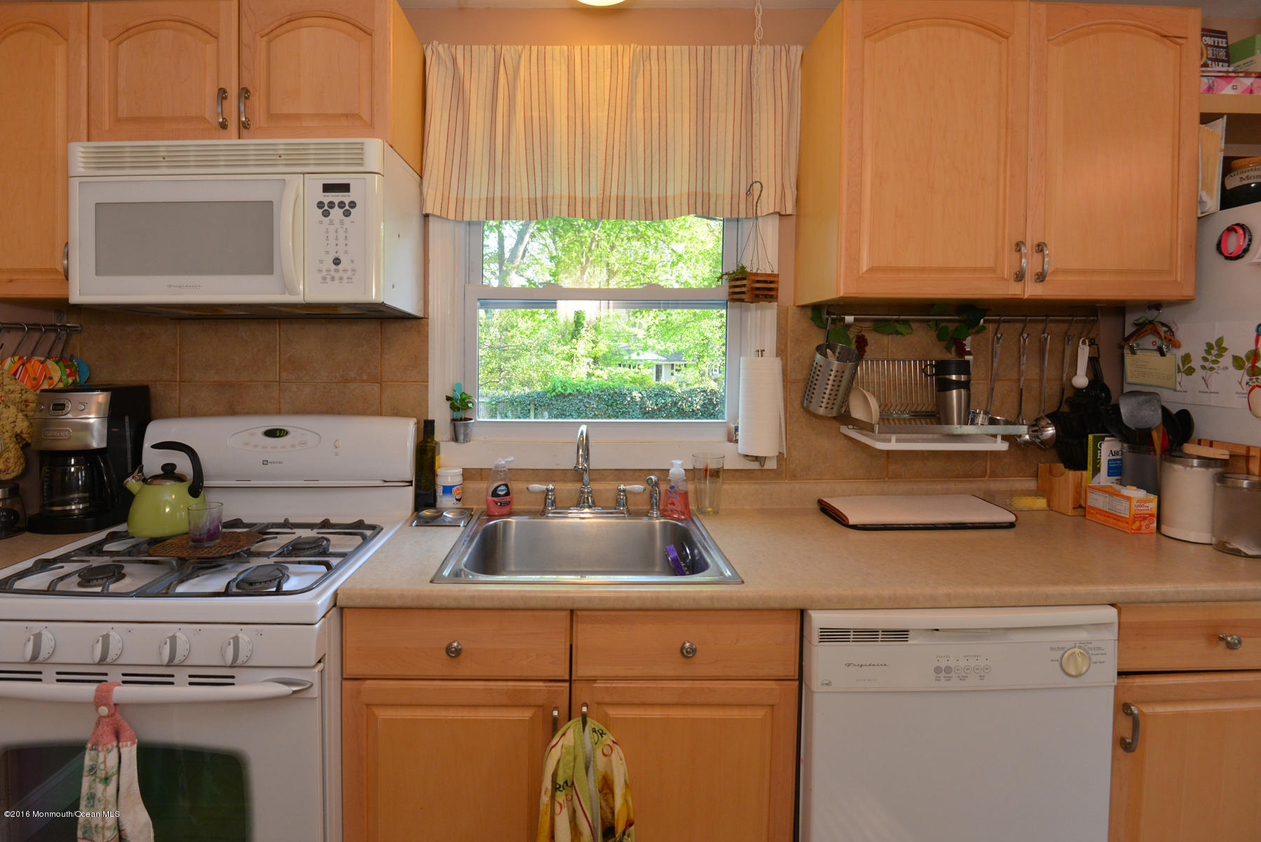 512 Lakewood Road Neptune Township, NJ 07753 - Photo 7 of 28 a kitchen with appliances a sink and cabinets