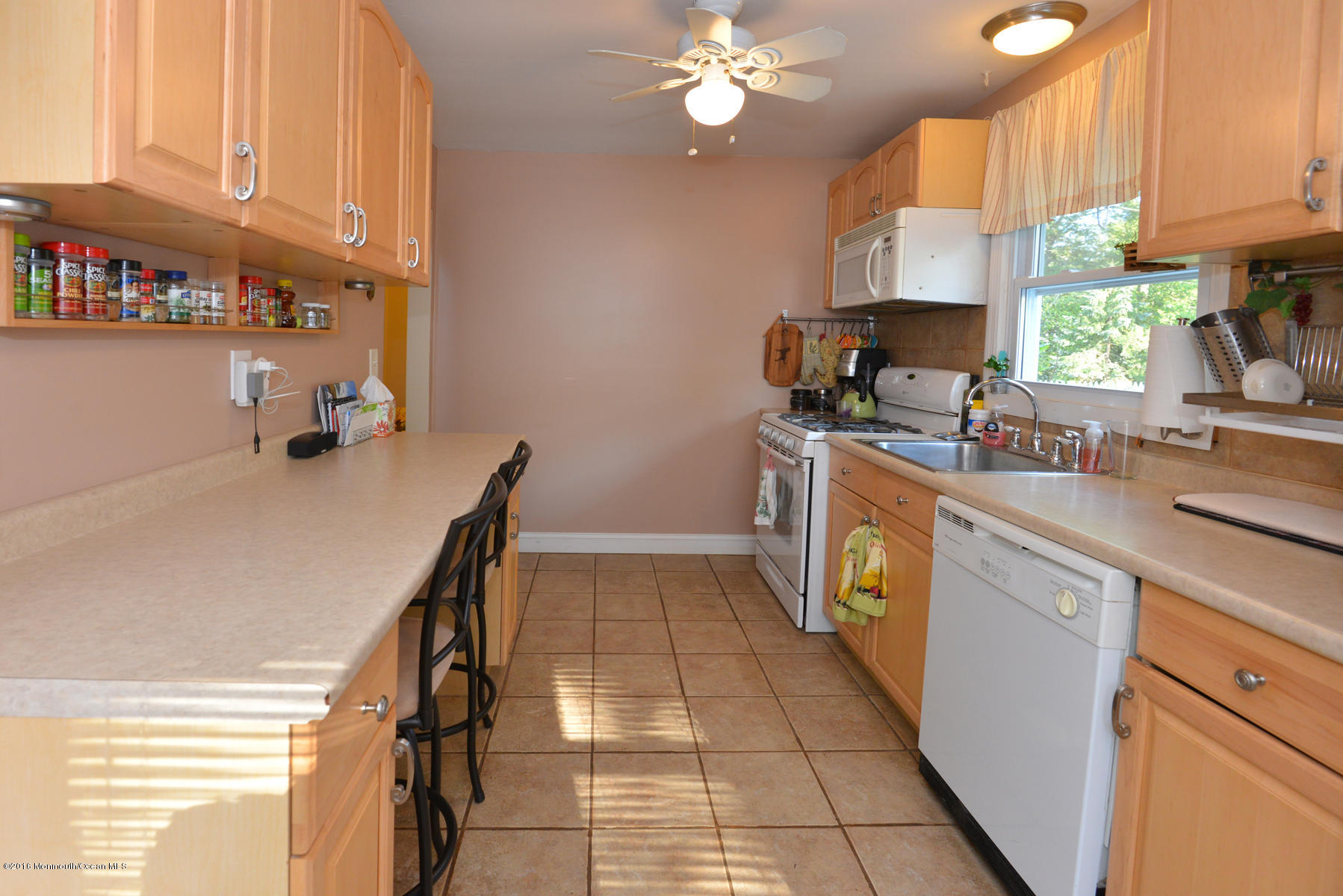 512 Lakewood Road Neptune Township, NJ 07753 - Photo 8 of 28 a kitchen with a sink appliances cabinets and a window