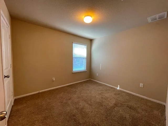 an empty room with windows and entrance