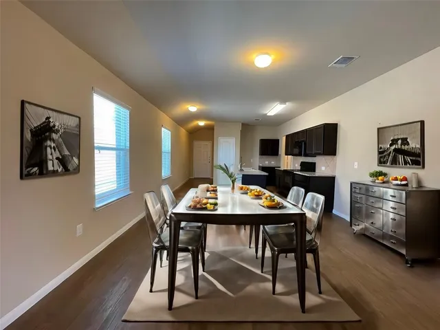 a view of a dining room with furniture window and wooden floor