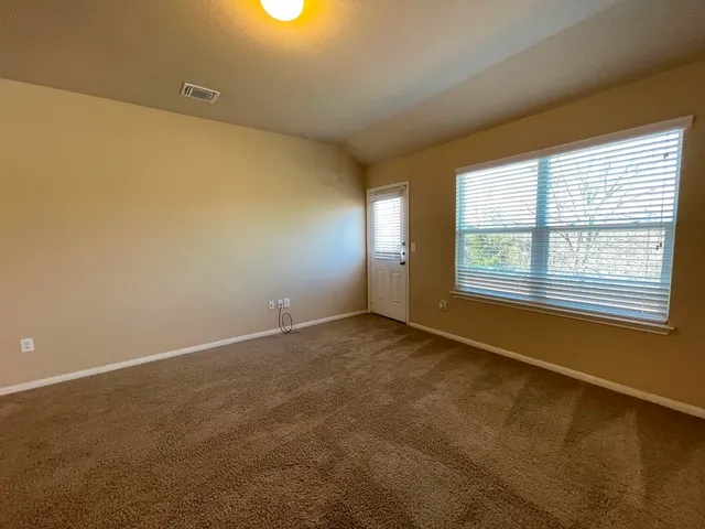 a view of an empty room with a window