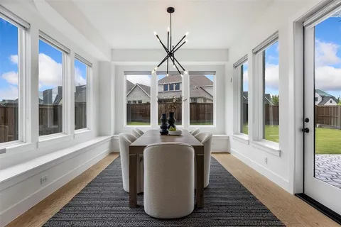 a dining room with table chairs and wooden floor