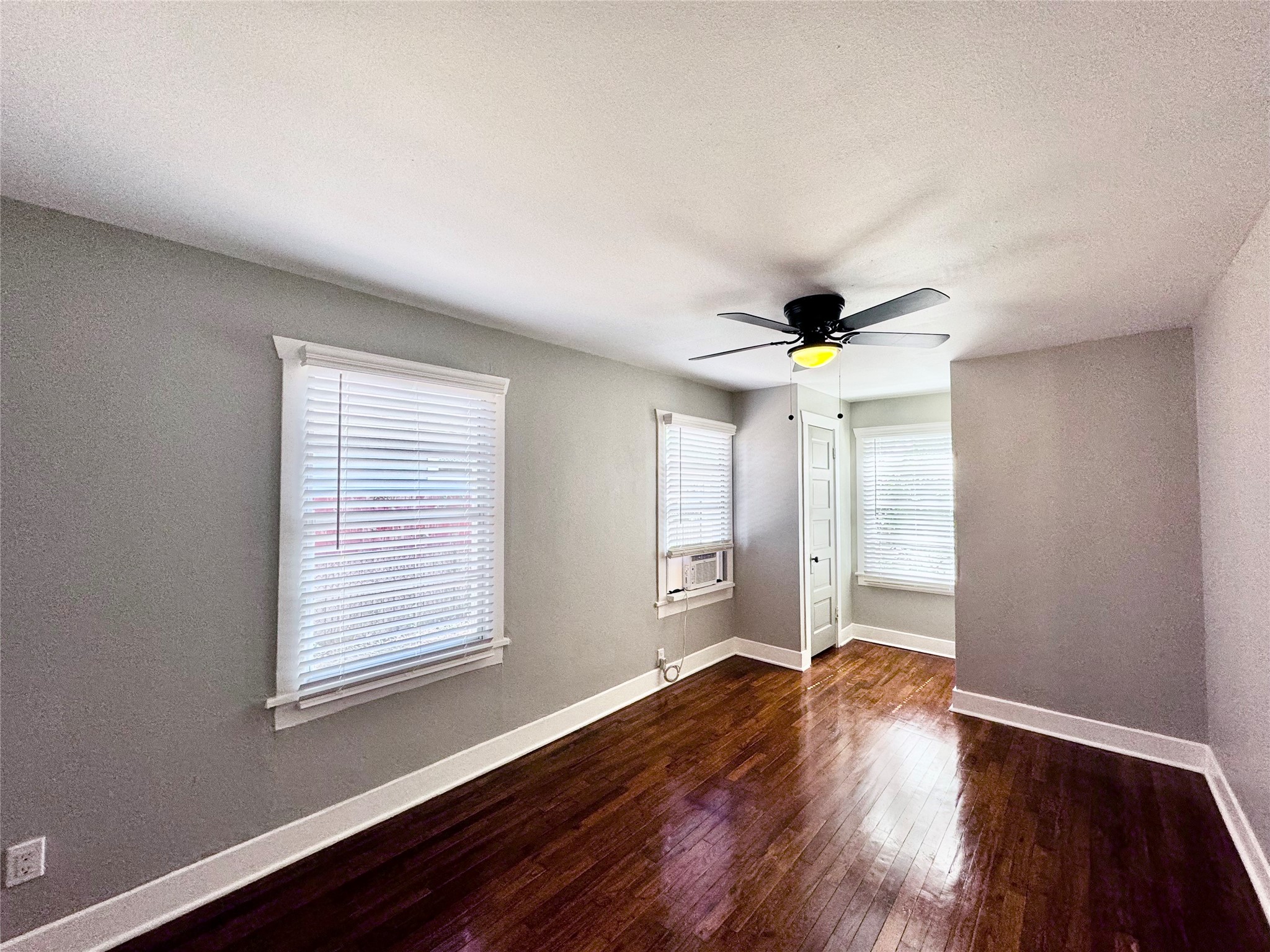 1018 Dunbar Street Houston, TX 77009 - Photo 21 of 30 Front bedroom is a good size with TWO closets! Calming neutral walls, refinished floors, plus a fan & light fixture and blinds on windows! Window unit has been removed bc there's now CENTRAL HVAC!