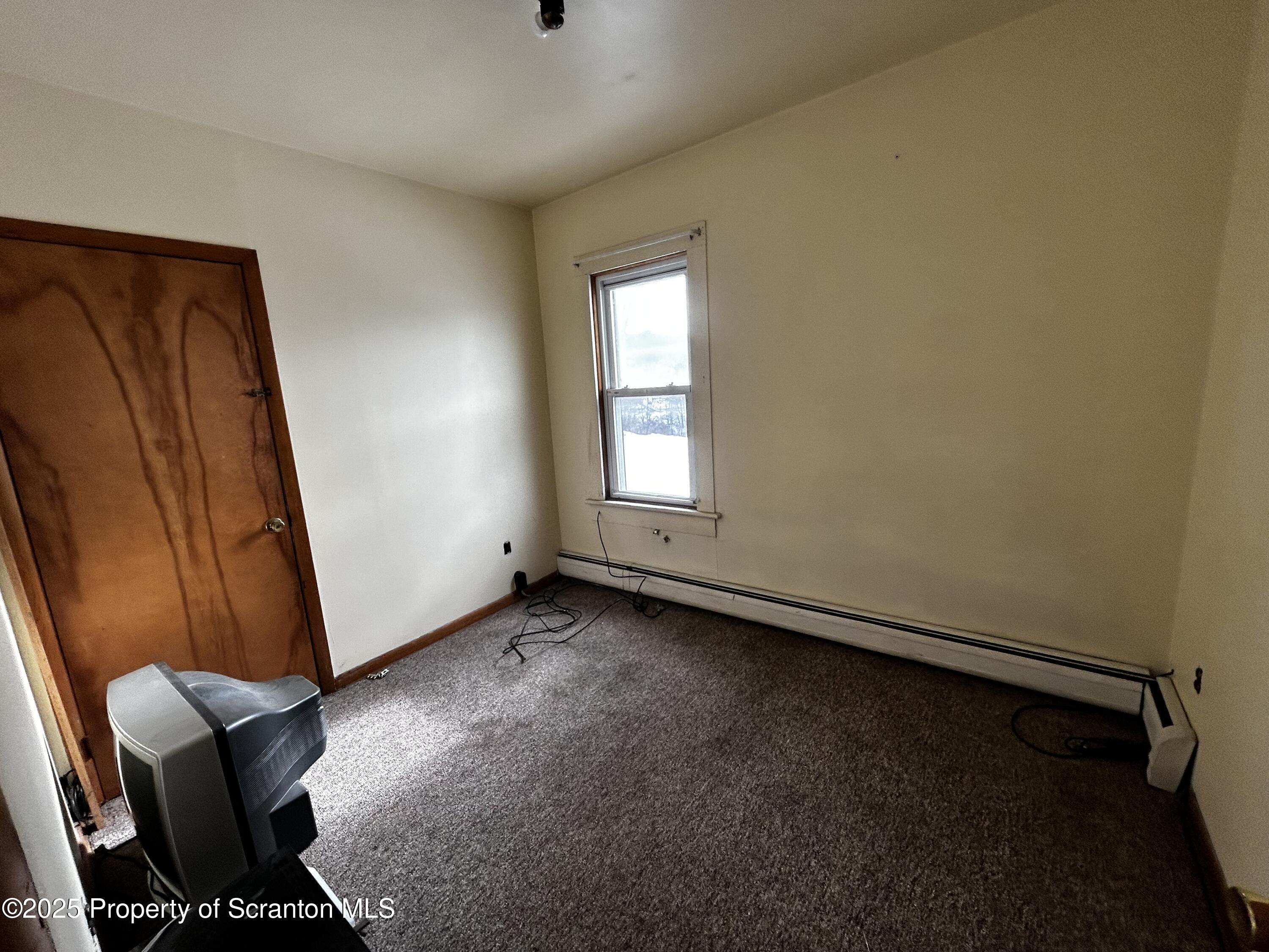 716 Main Street Carbondale, PA 18407 - Photo 7 of 9 an empty room with windows