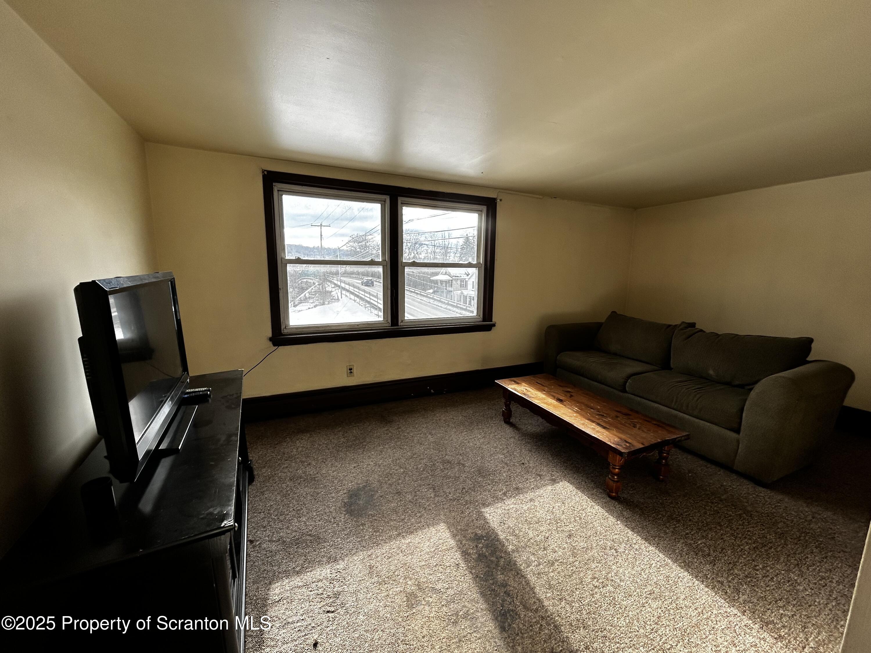 716 Main Street Carbondale, PA 18407 - Photo 8 of 9 a living room with furniture and a window