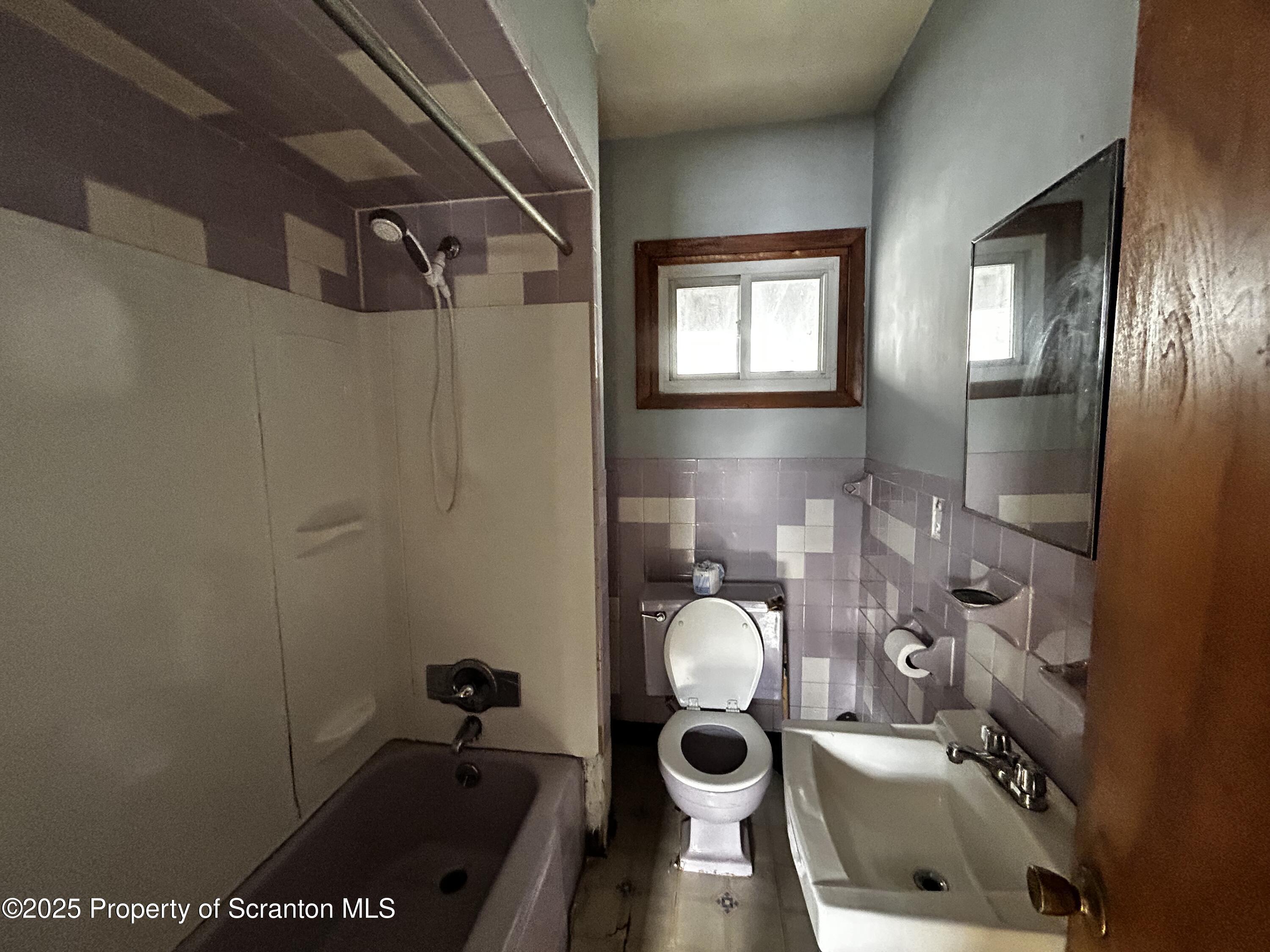716 Main Street Carbondale, PA 18407 - Photo 9 of 9 a bathroom with a sink mirror vanity and toilet