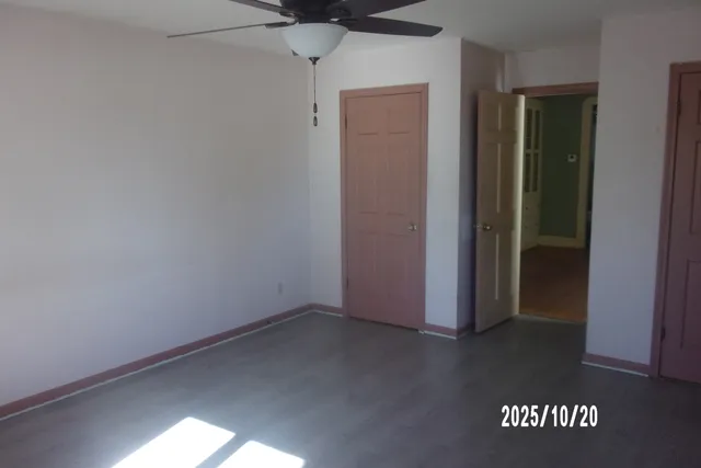 an entryway with a wooden floor & door