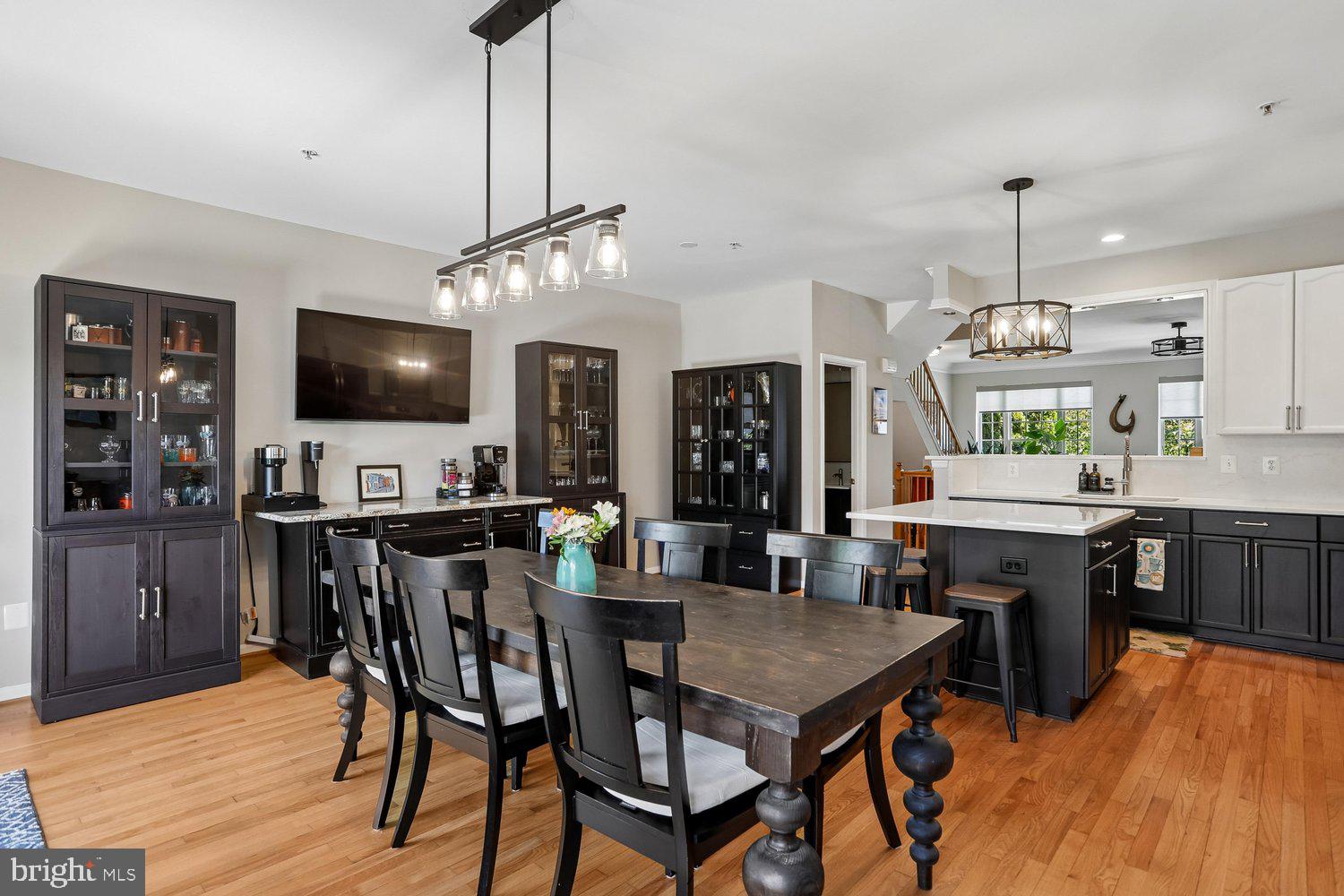 2530 Carrington Way Frederick, MD 21702 - Photo 11 of 38 a kitchen with a dining table chairs stainless steel appliances and cabinets