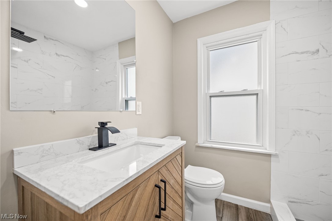 4892 Corliss Road Cleveland, OH 44124 - Photo 22 of 35 Bathroom with hardwood / wood-style floors, large vanity, and toilet