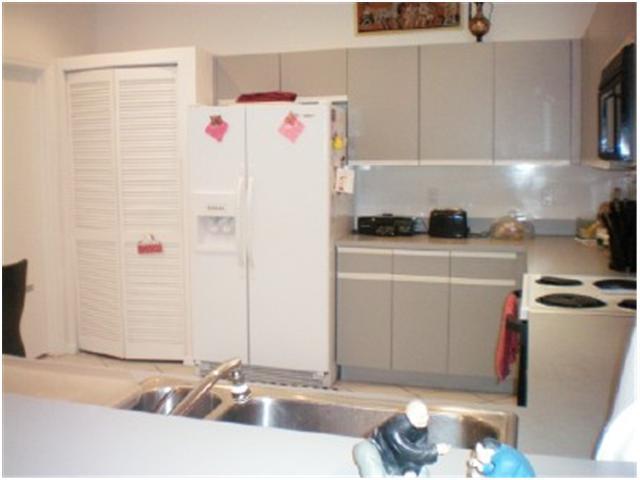 9998 Seacrest Circle, Unit B Boynton Beach, FL 33437 - Photo 11 of 23 a kitchen with a sink and a refrigerator