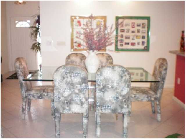 9998 Seacrest Circle, Unit B Boynton Beach, FL 33437 - Photo 4 of 23 a view of a dining room with furniture and a chandelier