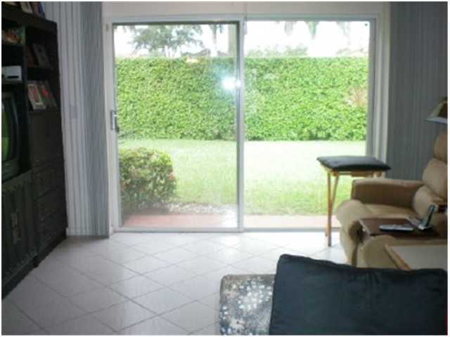 9998 Seacrest Circle, Unit B Boynton Beach, FL 33437 - Photo 8 of 23 a living room filled with furniture and a large window