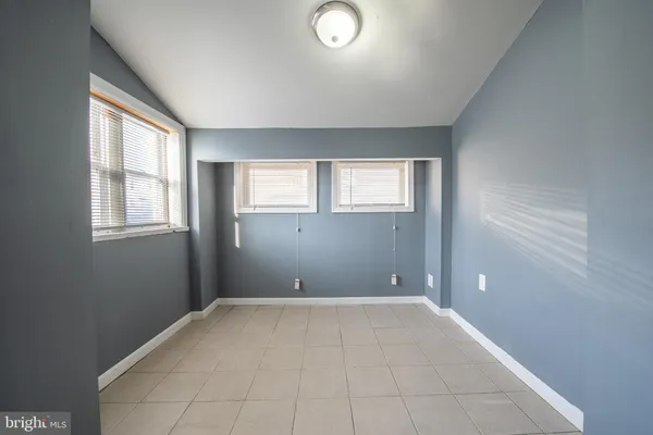 an empty room with windows and closet