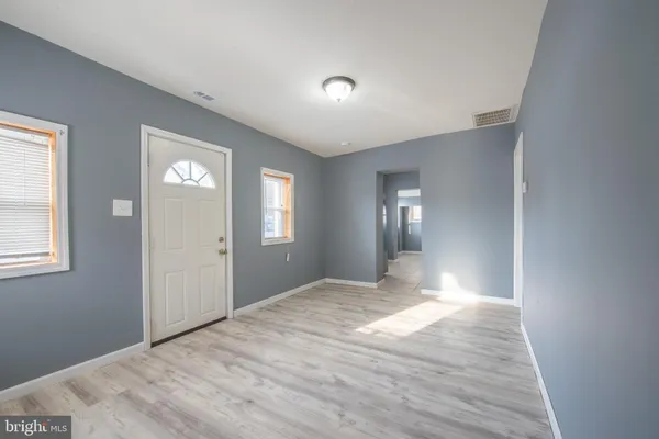 a view of wooden floor and windows in a room