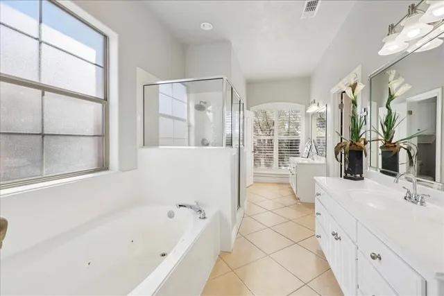 a bedroom with a bed furniture and a flat screen tv