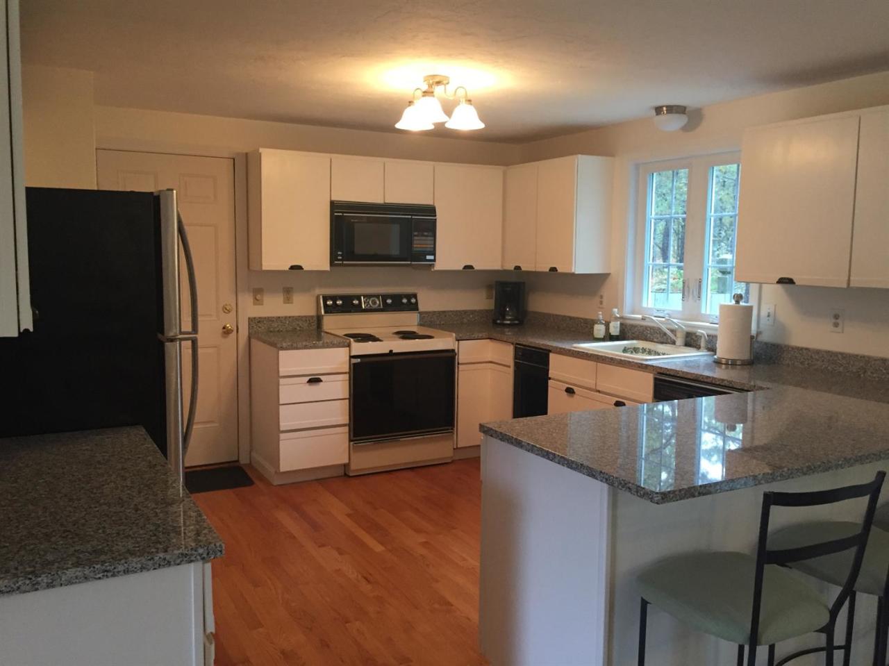 17 Wintergreen Road Mashpee, MA 02649 - Photo 7 of 34 a kitchen with stainless steel appliances granite countertop a stove top oven a refrigerator a sink and a granite counter tops