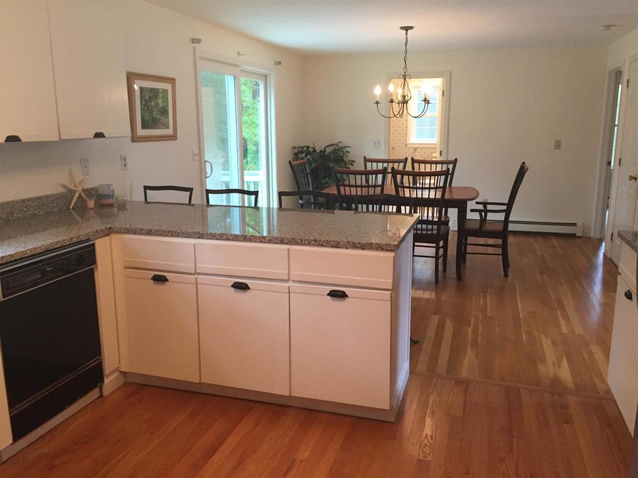 17 Wintergreen Road Mashpee, MA 02649 - Photo 9 of 34 a kitchen with stainless steel appliances granite countertop wooden floor window dining table and chairs