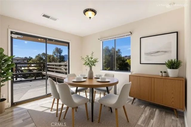 a kitchen with stainless steel appliances granite countertop a refrigerator a stove and a cabinets with wooden floor