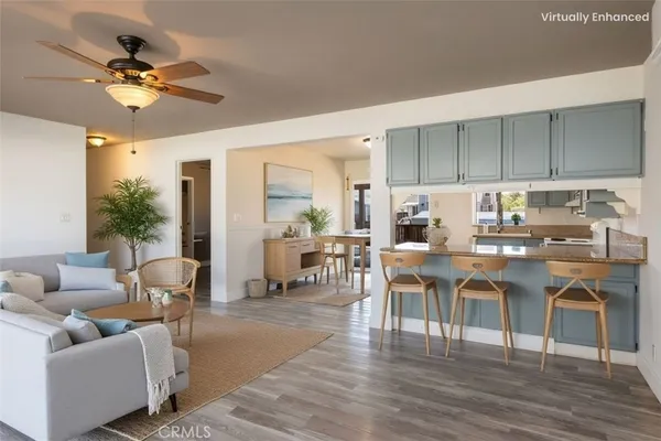 a kitchen with kitchen island white cabinets and stainless steel appliances