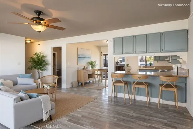 a kitchen with kitchen island white cabinets and stainless steel appliances