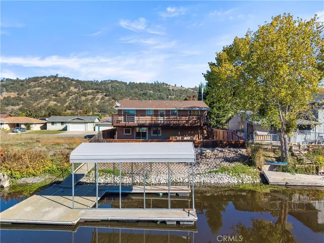an aerial view of a city with lots of residential buildings ocean and mountain view in back
