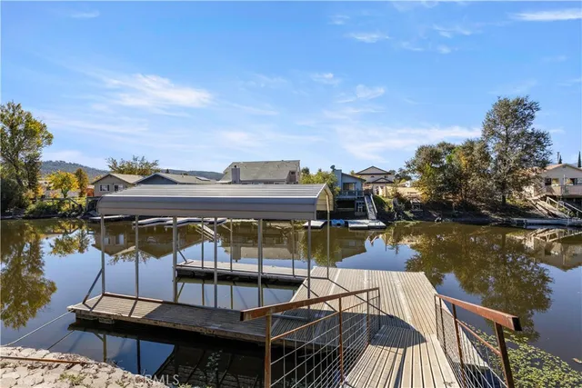 an aerial view of lake residential houses with outdoor space and mountain view