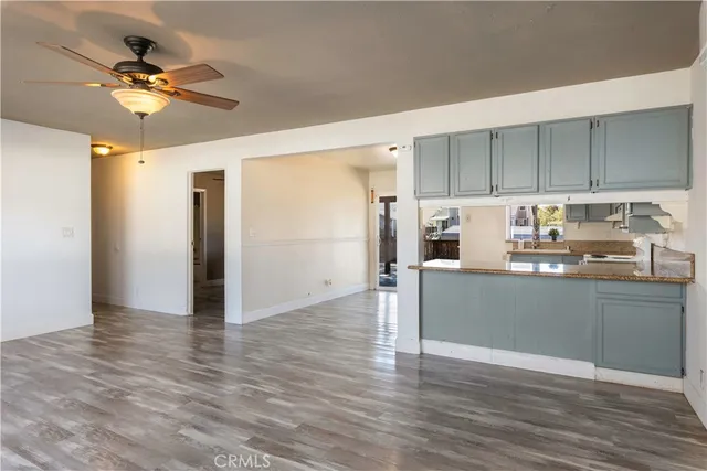 a living room with furniture and kitchen view