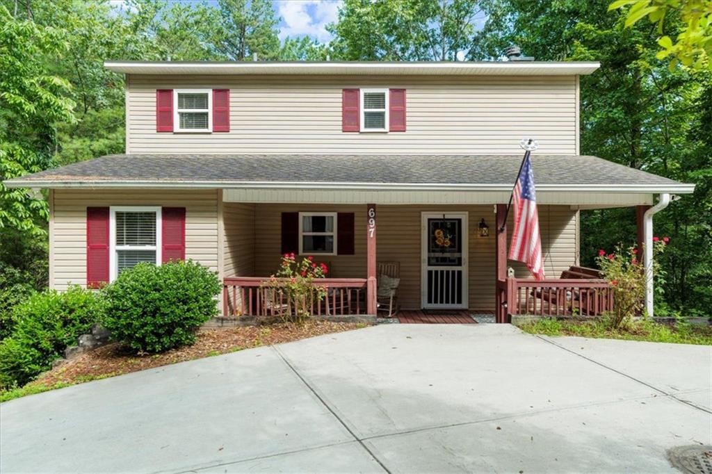 697 Zeppelin Strasse Helen, GA 30545 - Photo 2 of 41 a patio with a table and chairs under an umbrella