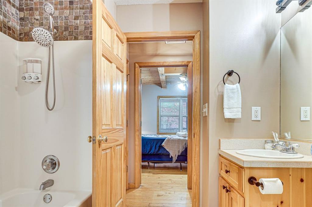 697 Zeppelin Strasse Helen, GA 30545 - Photo 23 of 41 a en suite bathroom with a granite countertop sink and a mirror