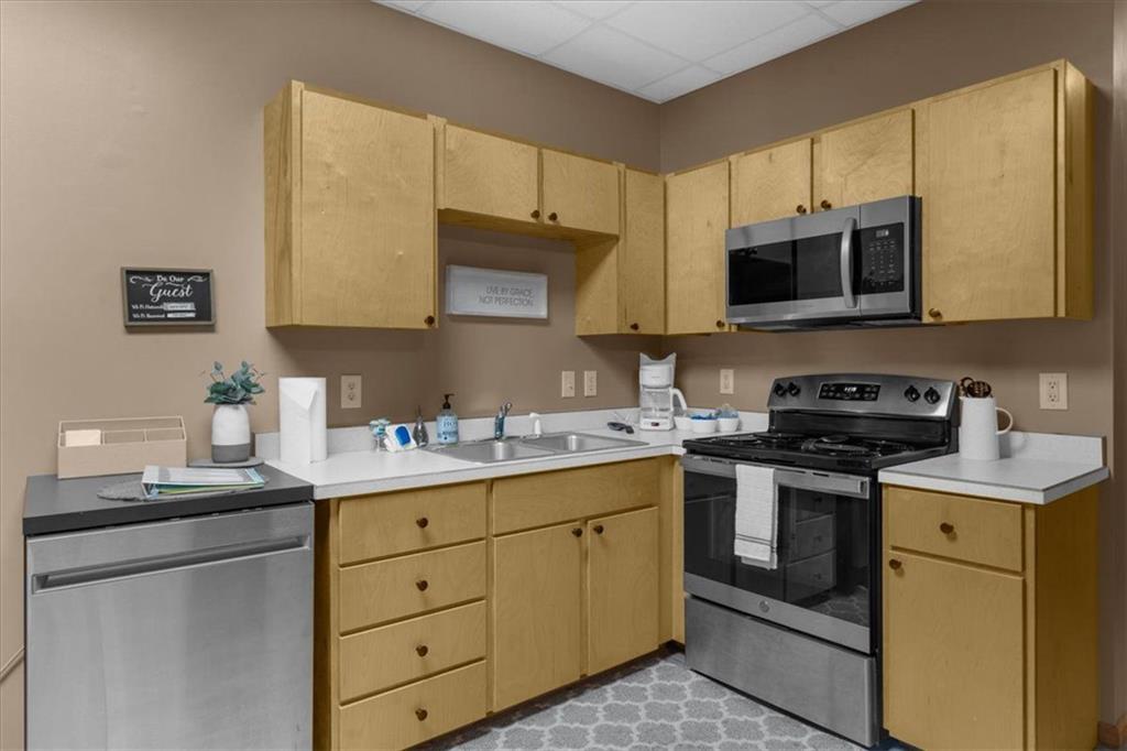 697 Zeppelin Strasse Helen, GA 30545 - Photo 30 of 41 a kitchen with stainless steel appliances granite countertop a sink stove and microwave