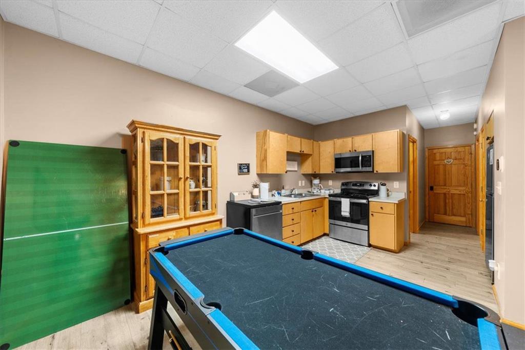 697 Zeppelin Strasse Helen, GA 30545 - Photo 35 of 41 a kitchen with stainless steel appliances granite countertop a refrigerator a sink dishwasher a dining table and chairs with the outer view