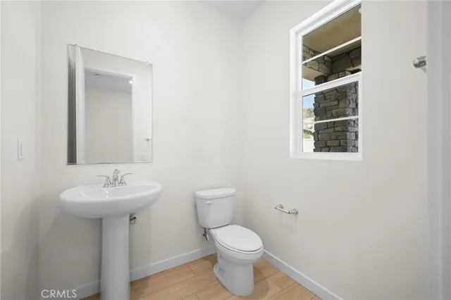 a bathroom with a sink toilet and a mirror