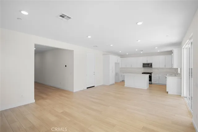 a view of a kitchen with a refrigerator and a sink