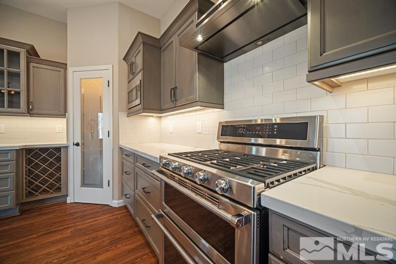 1745 Oxcart Court Reno, NV 89521 - Photo 8 of 20 a kitchen with granite countertop a stove and a refrigerator