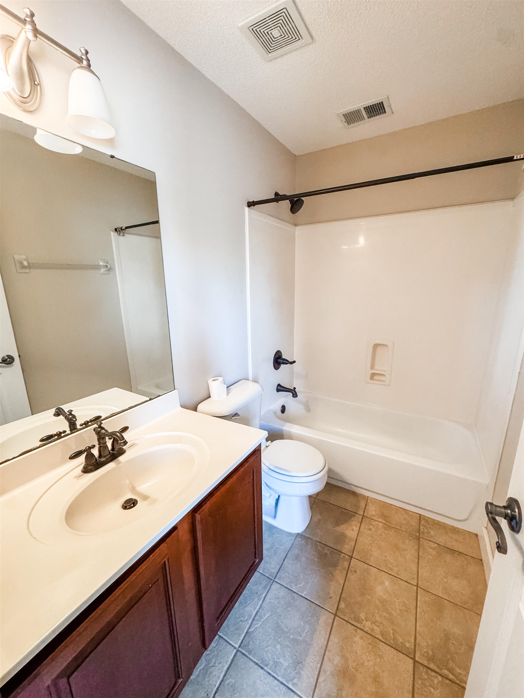10521 Red Stone Drive Collierville, TN 38017 - Photo 12 of 15 a bathroom with a sink mirror toilet and bathtub