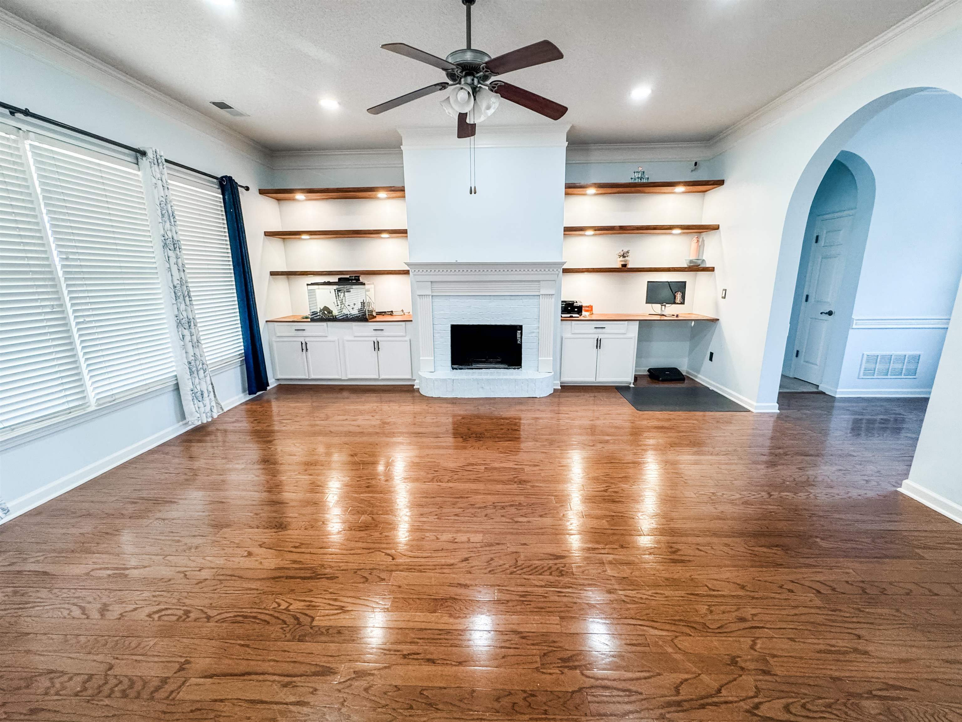 10521 Red Stone Drive Collierville, TN 38017 - Photo 3 of 15 a view of a livingroom with a fireplace a ceiling fan and window