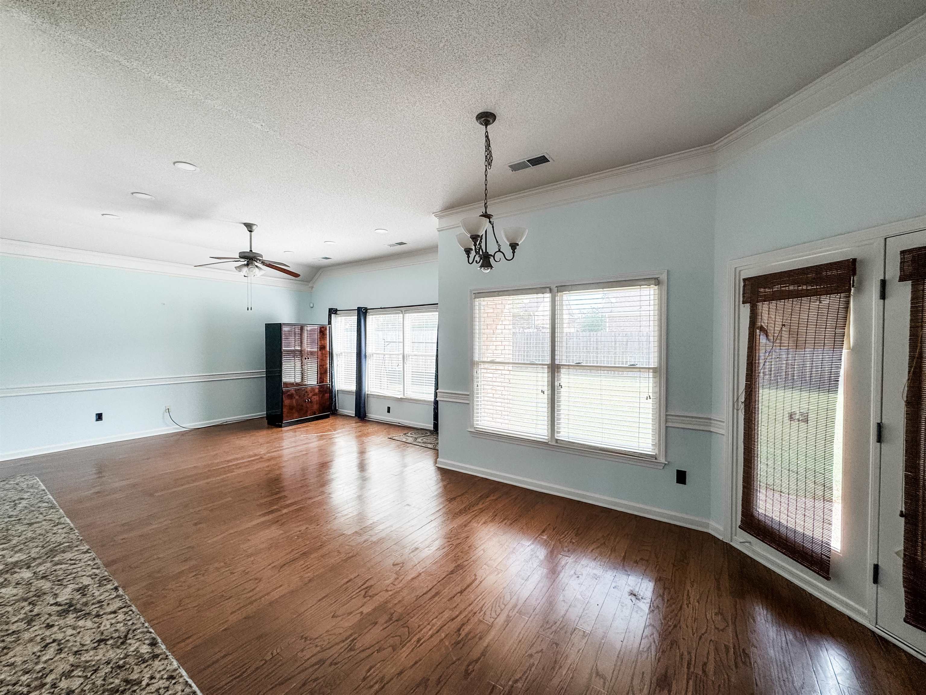 10521 Red Stone Drive Collierville, TN 38017 - Photo 5 of 15 a view of an empty room with wooden floor and a window