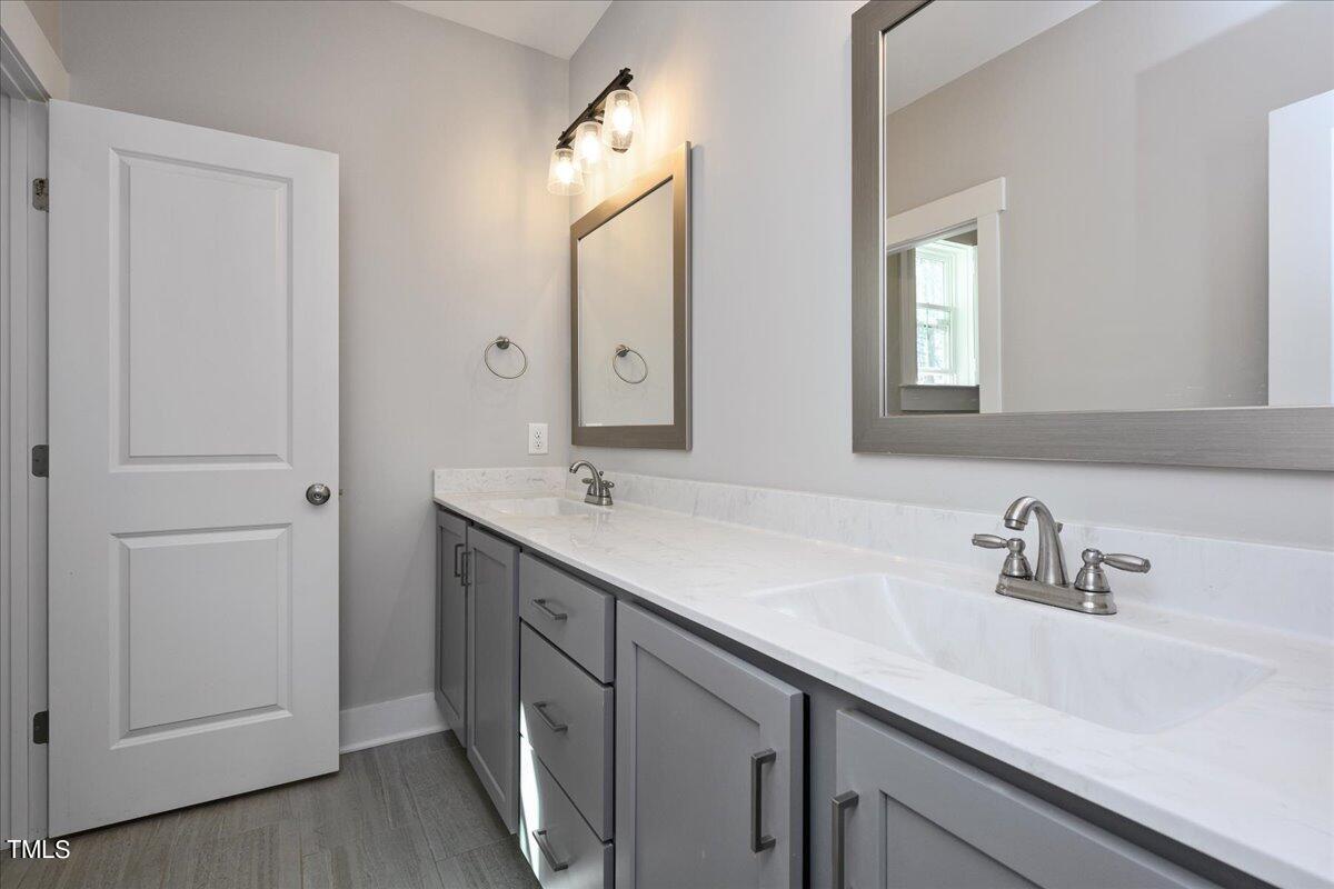 1415 Pine Ridge Road Spring Hope, NC 27882 - Photo 17 of 25 a bathroom with 2 sink and a mirror
